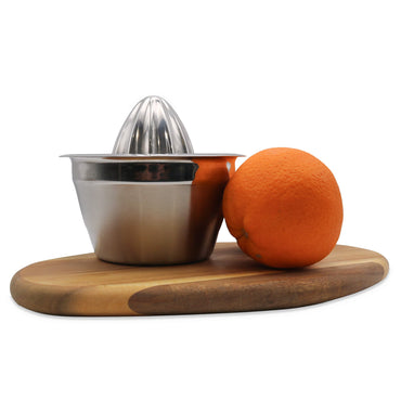 Stainless steel manual juicer with a whole orange on a wooden board against a white background