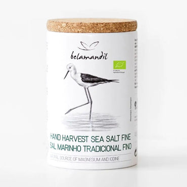 Container of belamandil hand harvest sea salt with a cork lid on a white background
