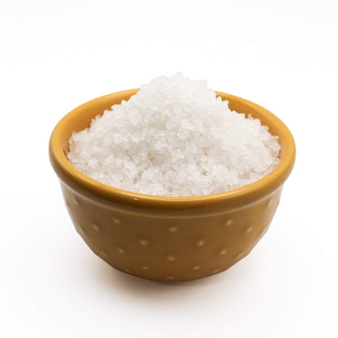 Brown bowl filled with white salt on a white background