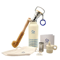 Set of eco-friendly products including a bottle, brush, and accessories with Grande branding on a white background.
