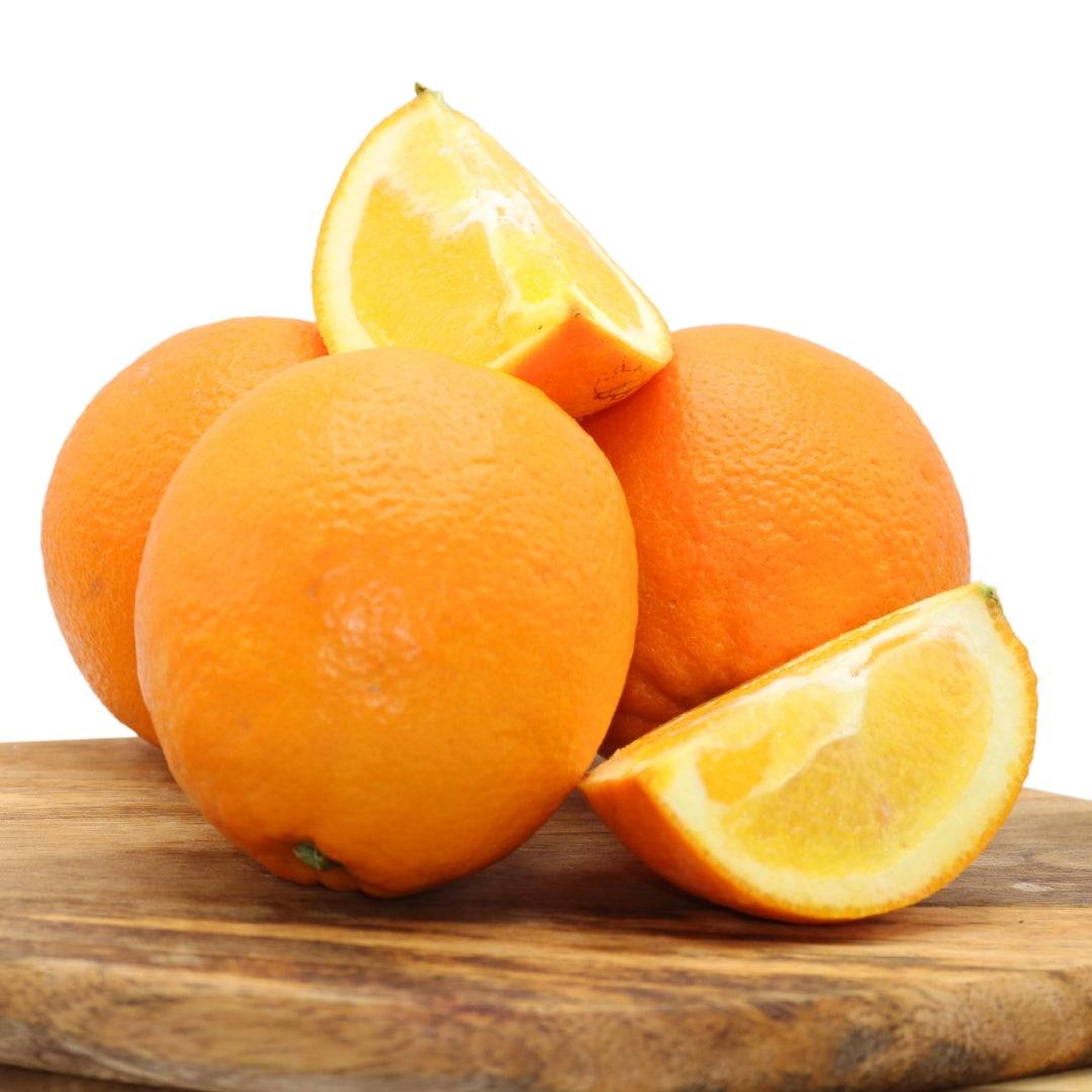 Ripe Algarve oranges with sliced pieces on a wooden board. Enjoy fresh citrus fruits, perfect for a natural, sweet taste.