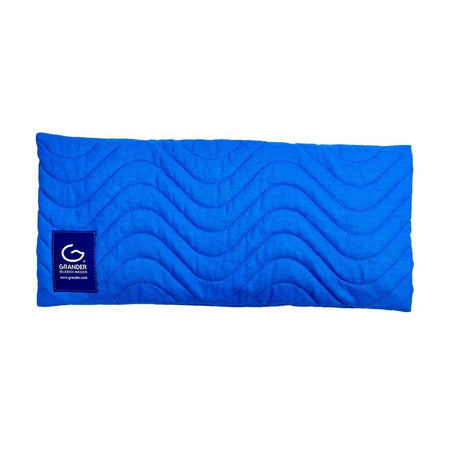 Blue quilted pillow with Grander logo on a white background