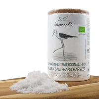 Sea salt container with a bird illustration on a wooden surface
