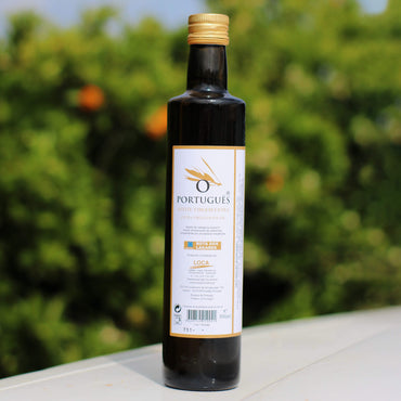 Bottle of Portuguese olive oil with a blurred green outdoor background