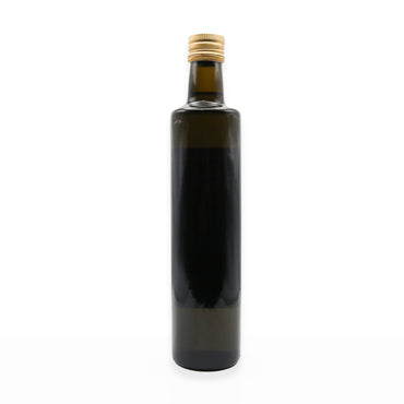 Dark glass bottle with a gold cap on a white background