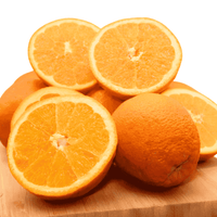 Oranges on a wooden cutting board with a white background