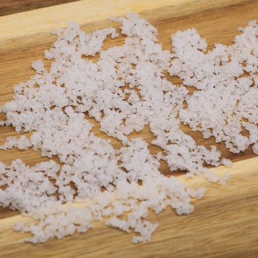 White sea salt product on a wooden surface