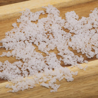 White sea salt product on a wooden surface